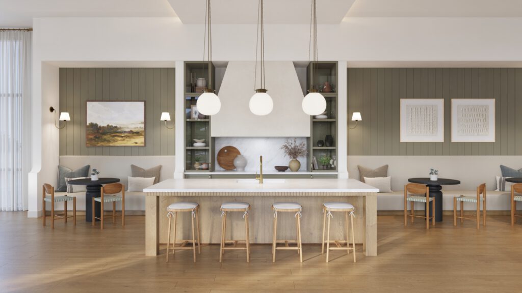 Modern clubroom kitchen featuring a light wood island with stools, pendant lights, and built-in shelving