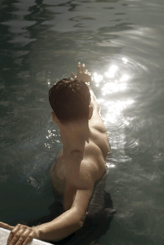 Person reaching out in a shimmering pool of water
