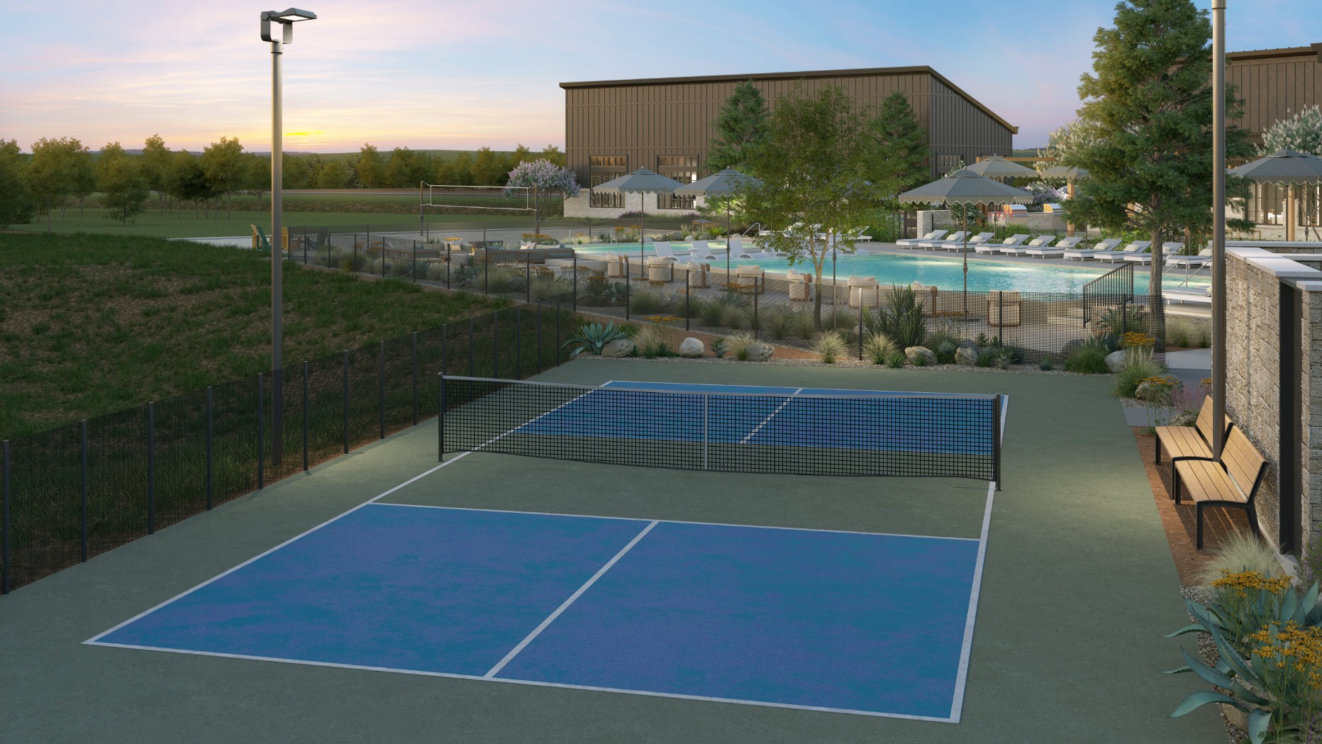 Fenced outdoor pickleball court next to a swimming pool area at sunset